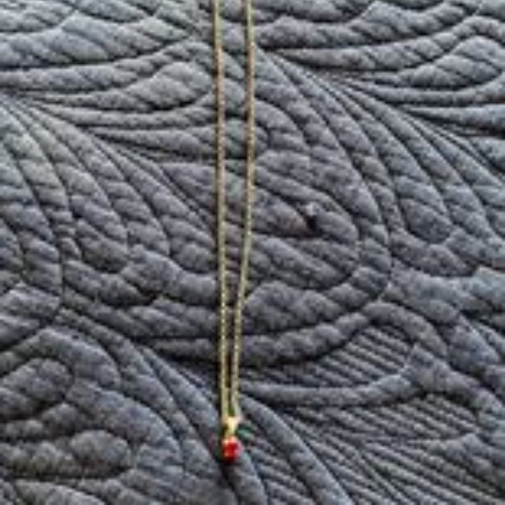 Silver 18" necklace with small red stone.